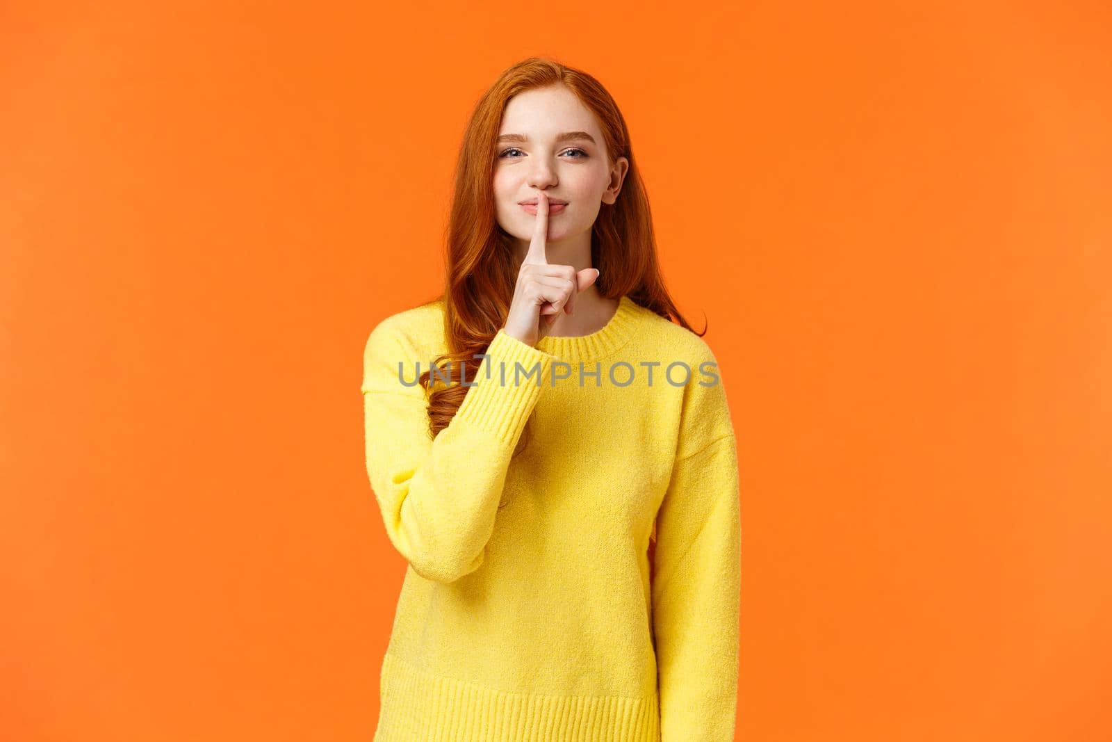 Gestures, winter holidays and people concept. Sensual and flirty cute redhead woman, girl prepare surprise asking keep secret, press index finger to lip, smiling and hushing, do shush gesture.