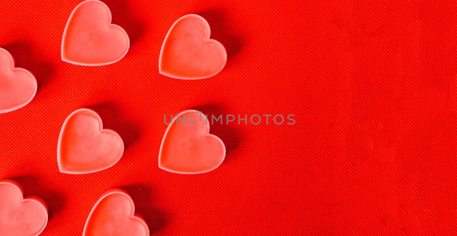 Happy valentines day.Many pink romantic hearts on red background.. Romantic Valentine day concept by andre_dechapelle