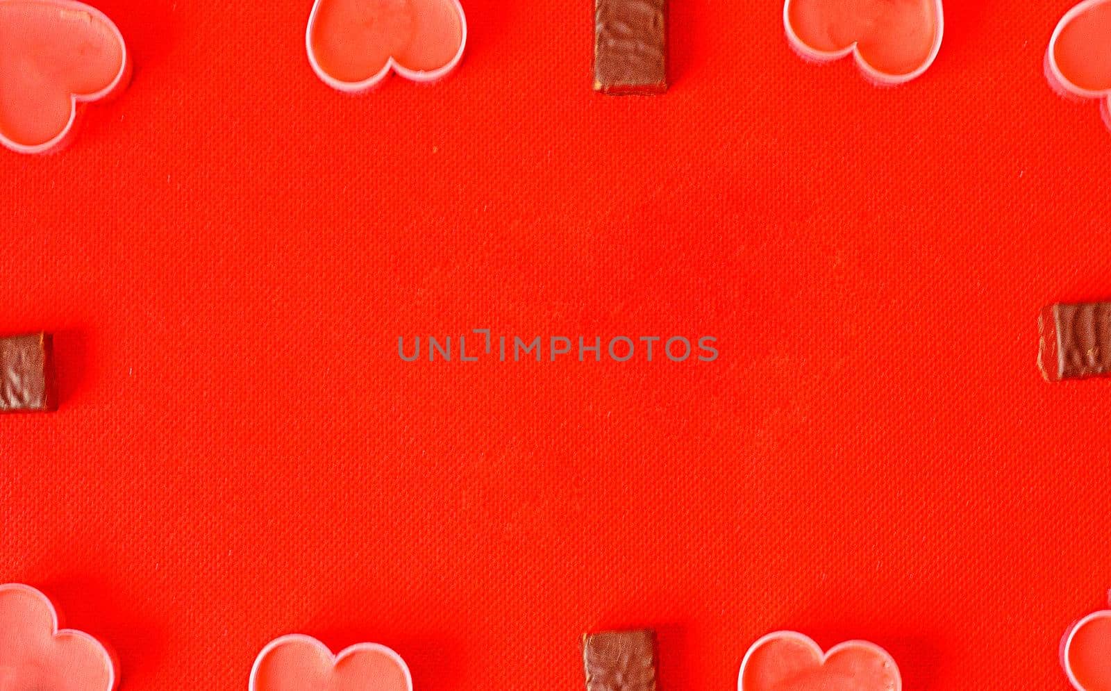 Happy valentines day.Many pink romantic hearts and chocolate candies on red background. Romantic Valentine day background by andre_dechapelle