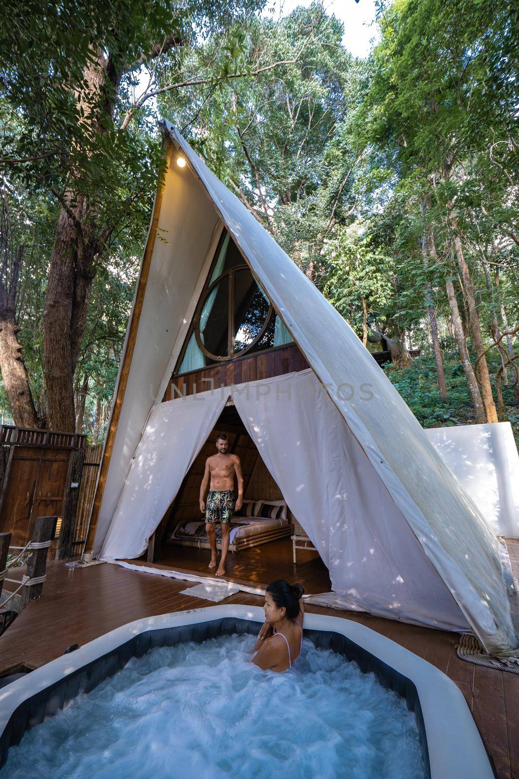 Glamping in Northern Thailand, couple man and woman in a tent with jacuzzi, man and woman in a bungalow in the mountains of Thailand.