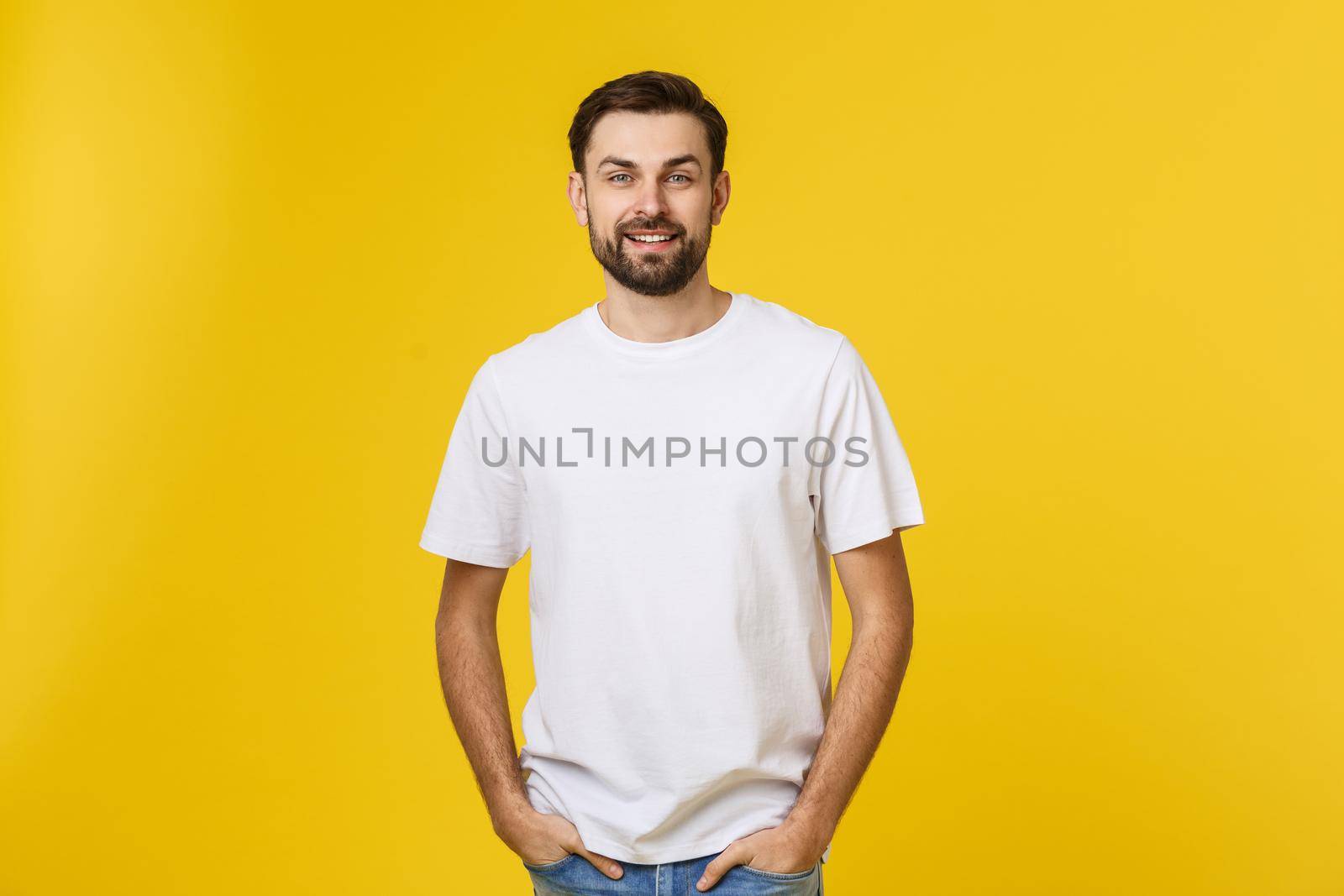 Portrait of a handsome young man smiling against yellow background by Benzoix