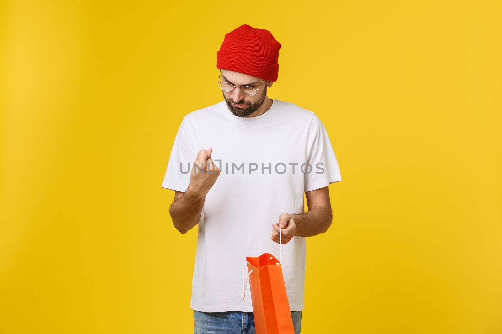Handsome man with shopping bag feeling worry and serious