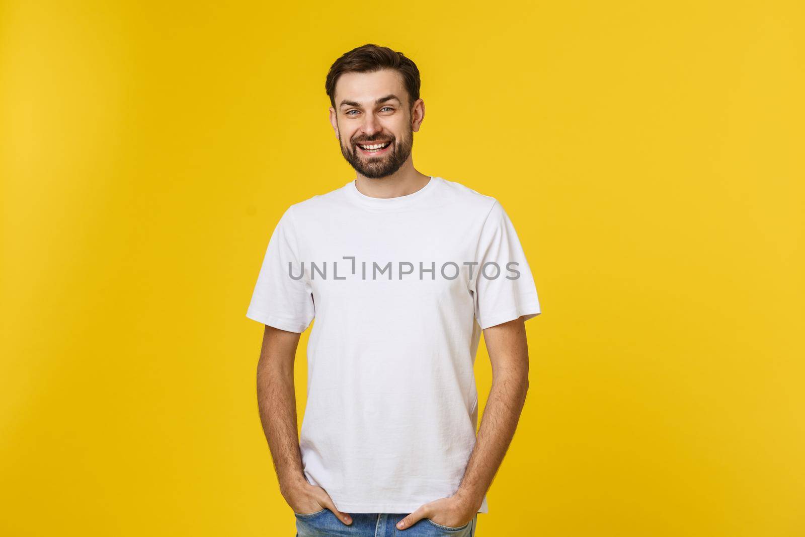 Portrait of a handsome young man smiling against yellow background by Benzoix