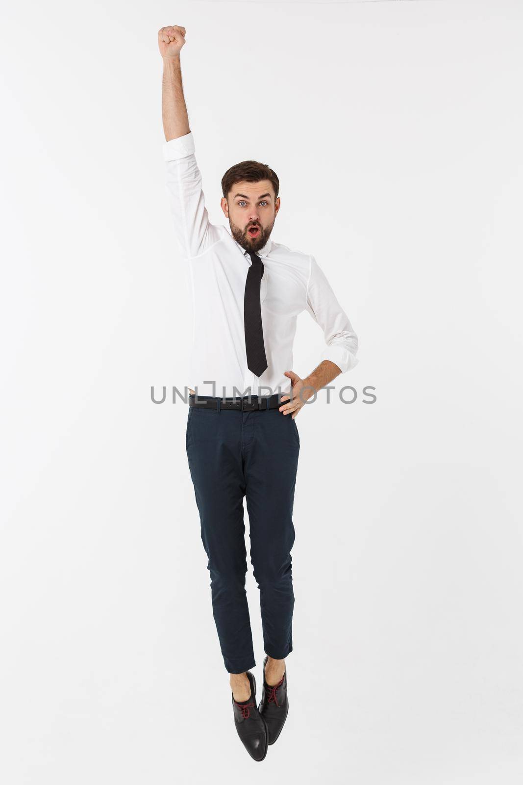 Young happy caucasian businessman jumping in the air , isolated on white background. by Benzoix
