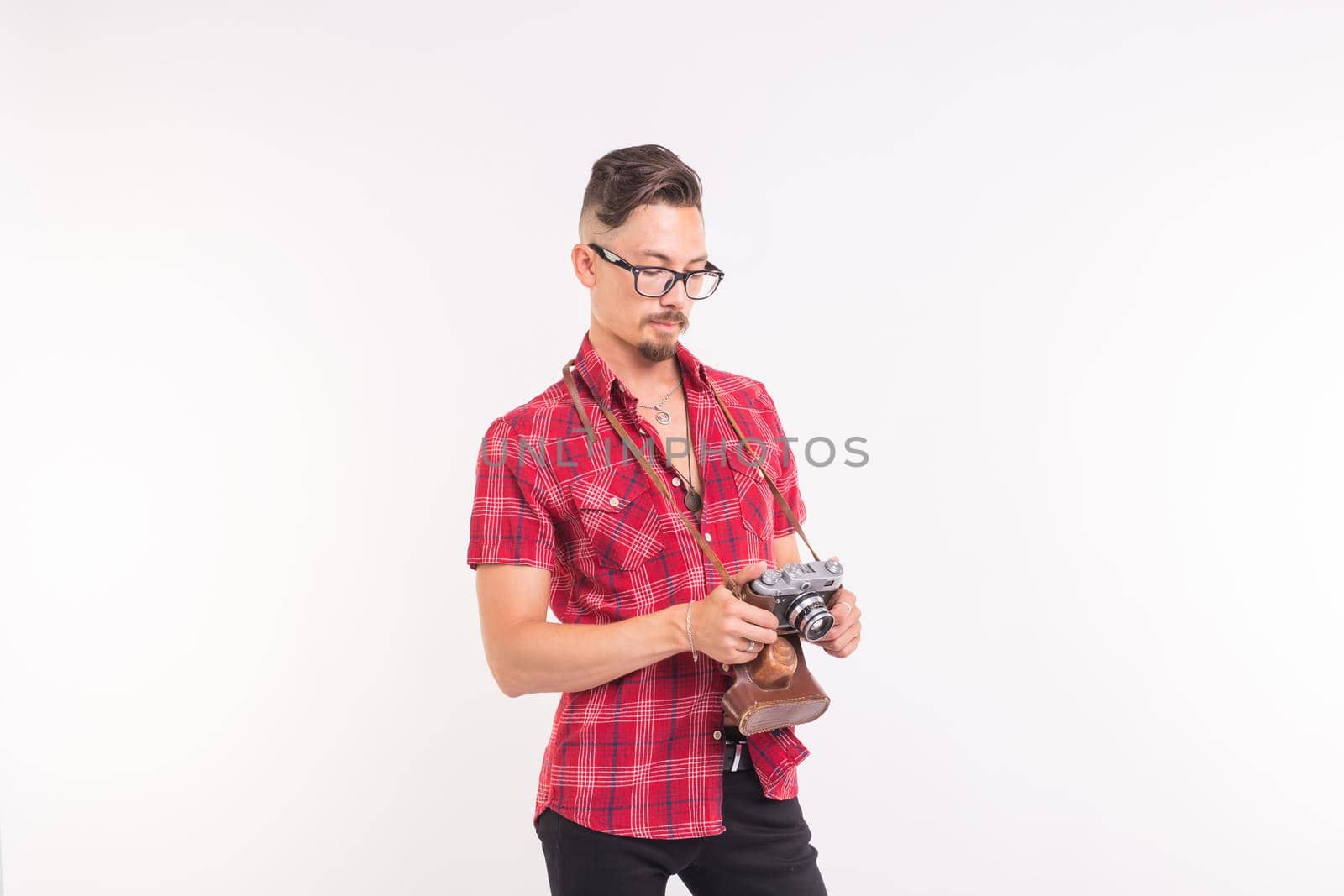 Vintage, photographer and people concept - handsome man with retro camera over white background with copy space.