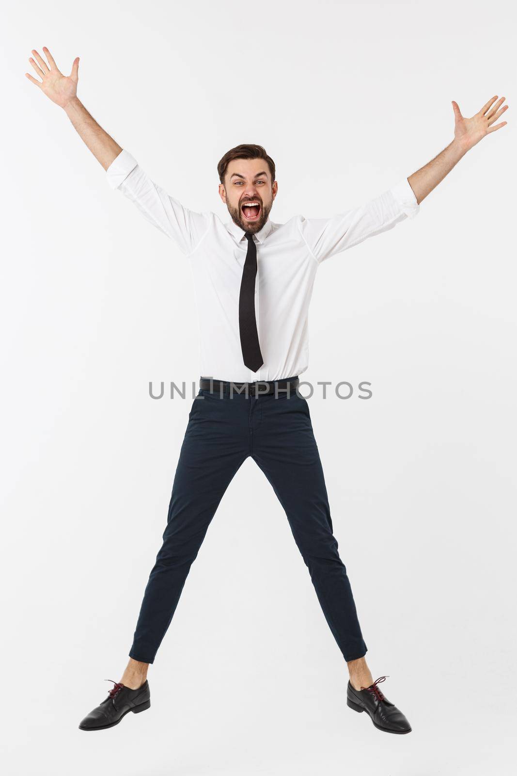 Young happy caucasian businessman jumping in the air , isolated on white background