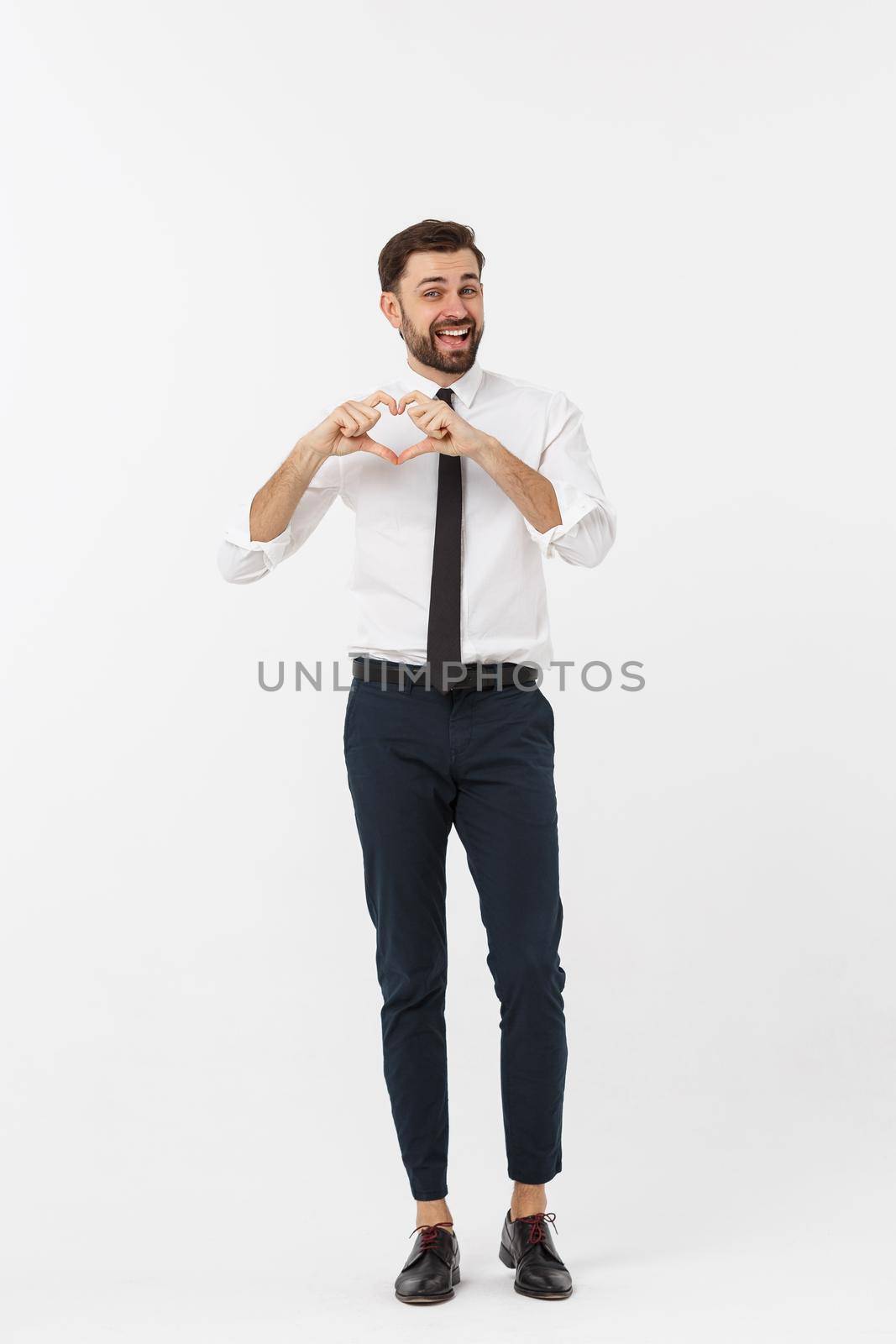 Business Concept: Portrait of charming attractive businessman holding hands in heart gesture and lifting eyebrows while smiling. by Benzoix