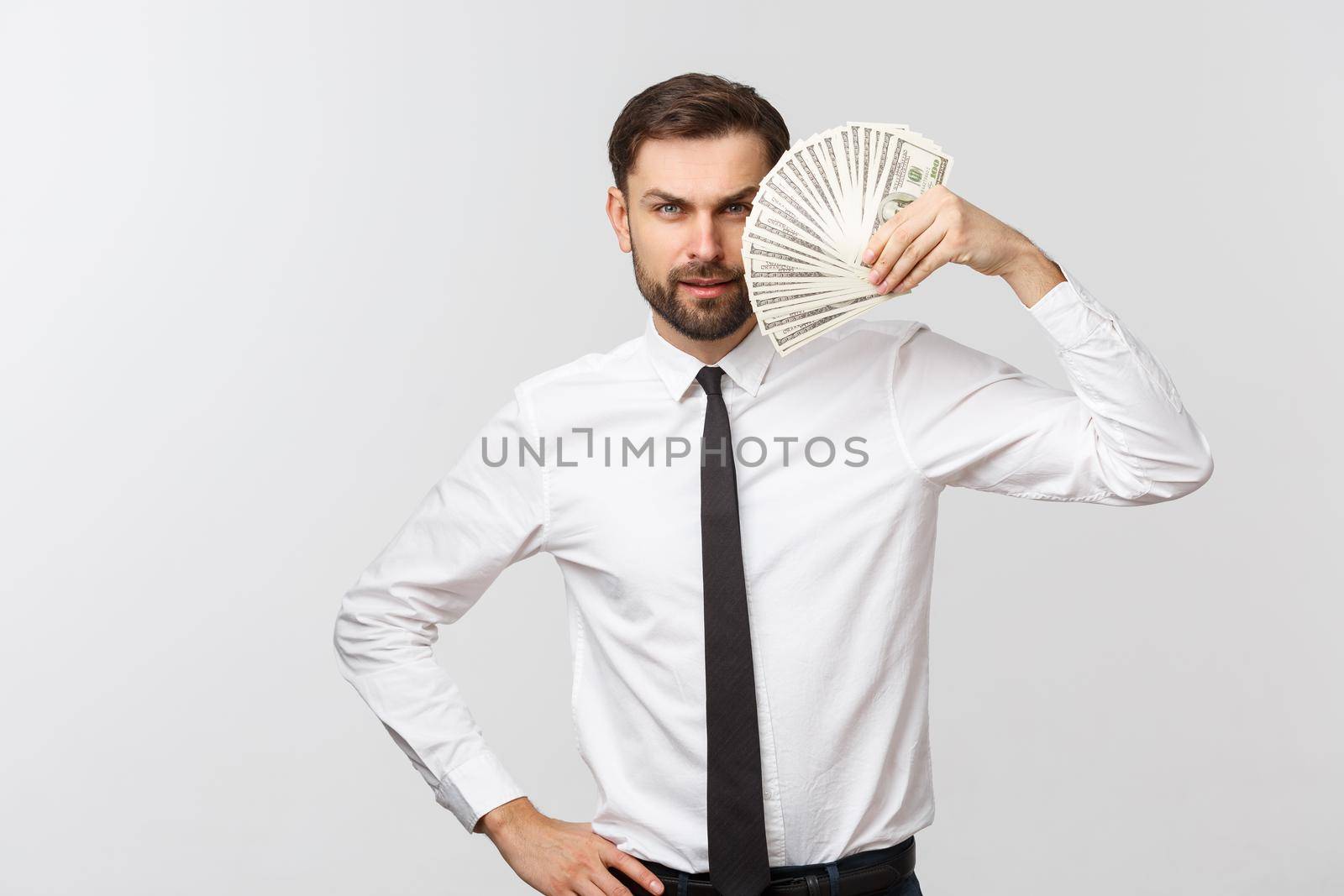 Portrait of a business man holding money, isolated on white