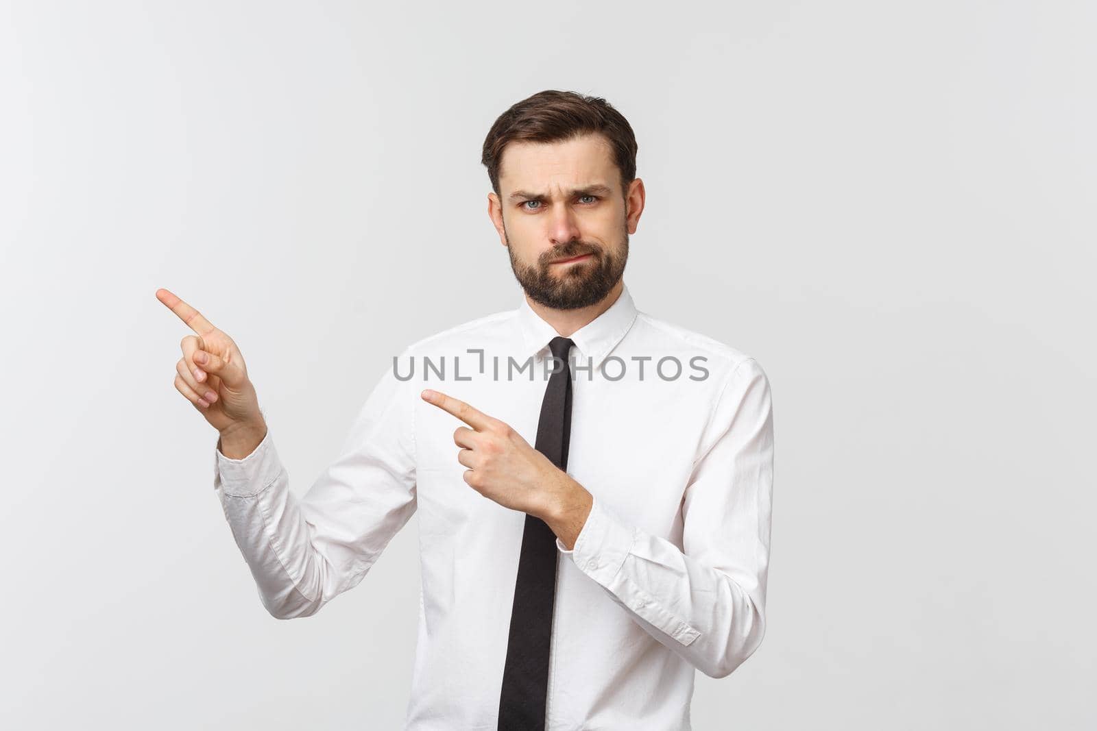 Bearded serious businessman pointing finger at you. Isolated on grey studio background by Benzoix