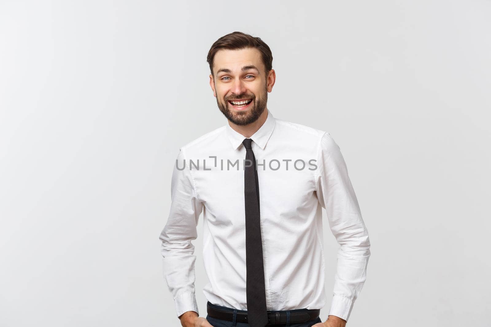 Portrait of young happy smiling business man, isolated over white background by Benzoix