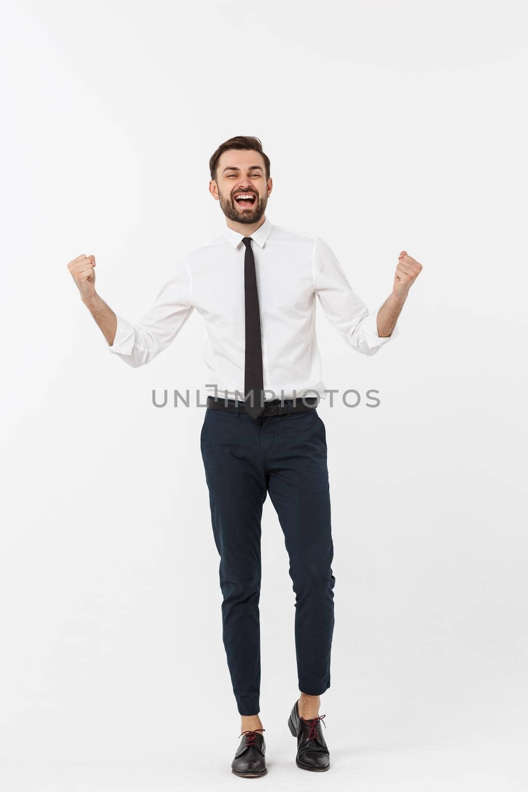full-length portrait of happy businessman in formal wear with raising hands up. isolated on white background