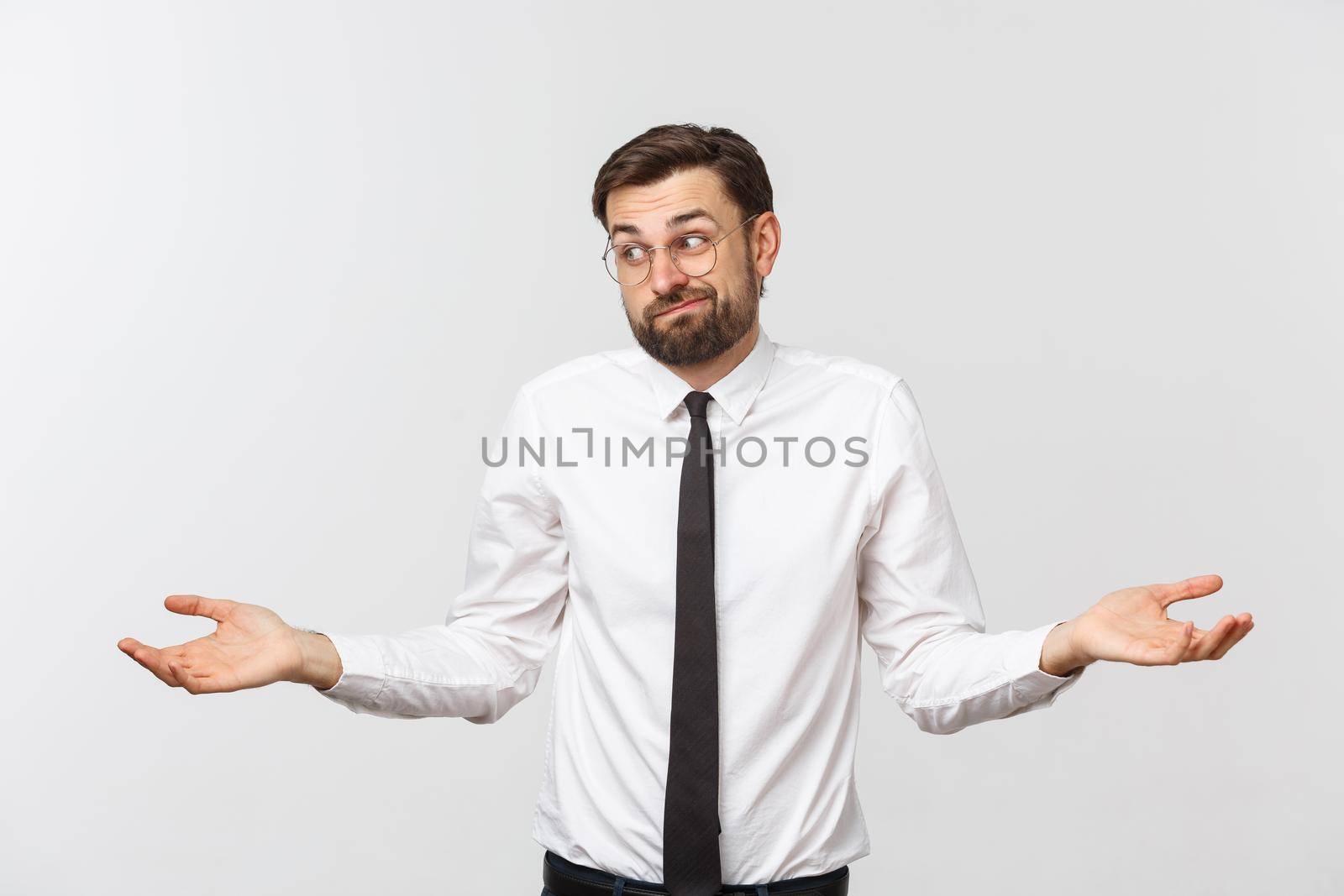 Young happy businessman gesturing with hands and showing balance or do not care