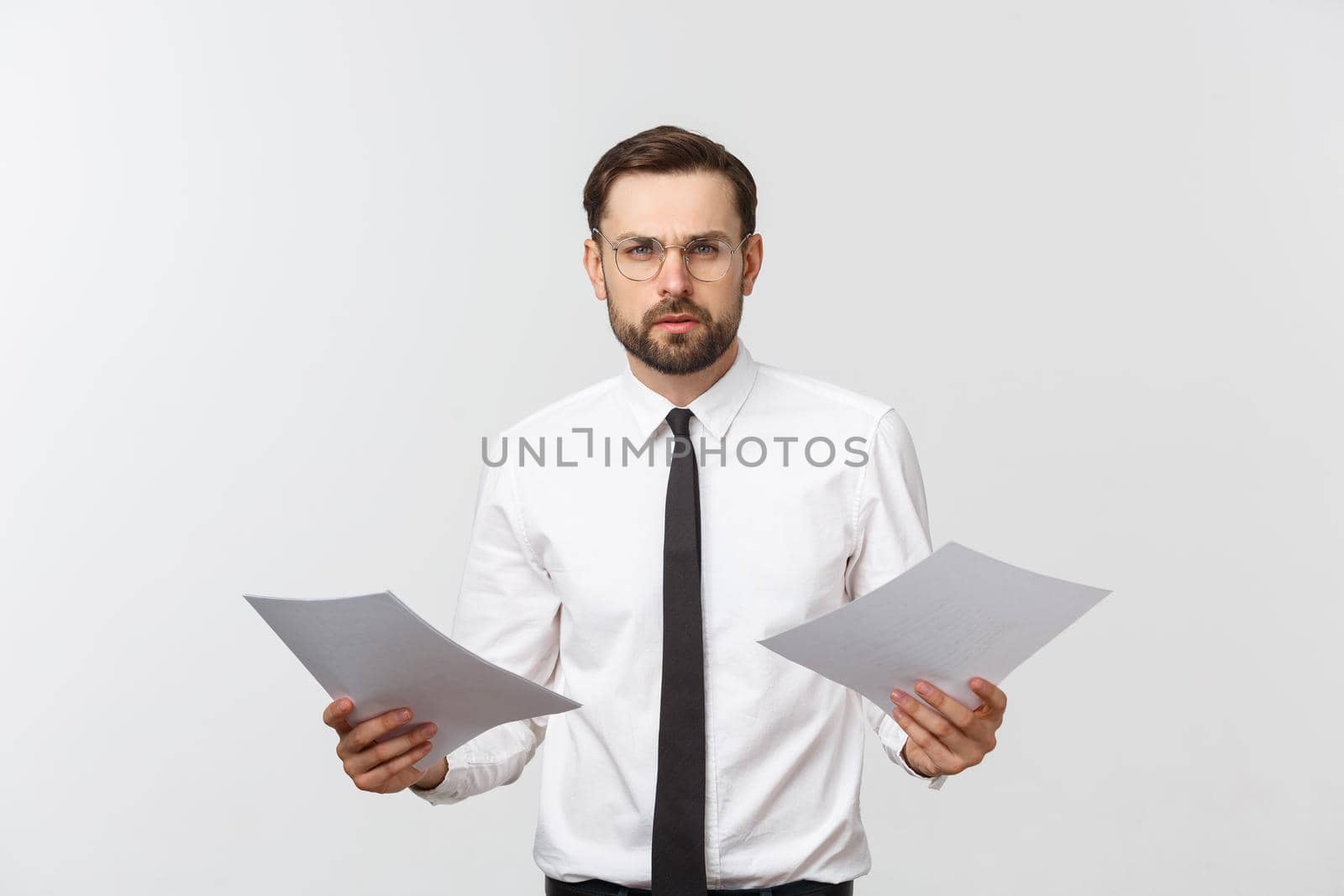 young business man serious writing on clipboard, Handsome businessman wear elegant suit and tie isolated over white background. by Benzoix