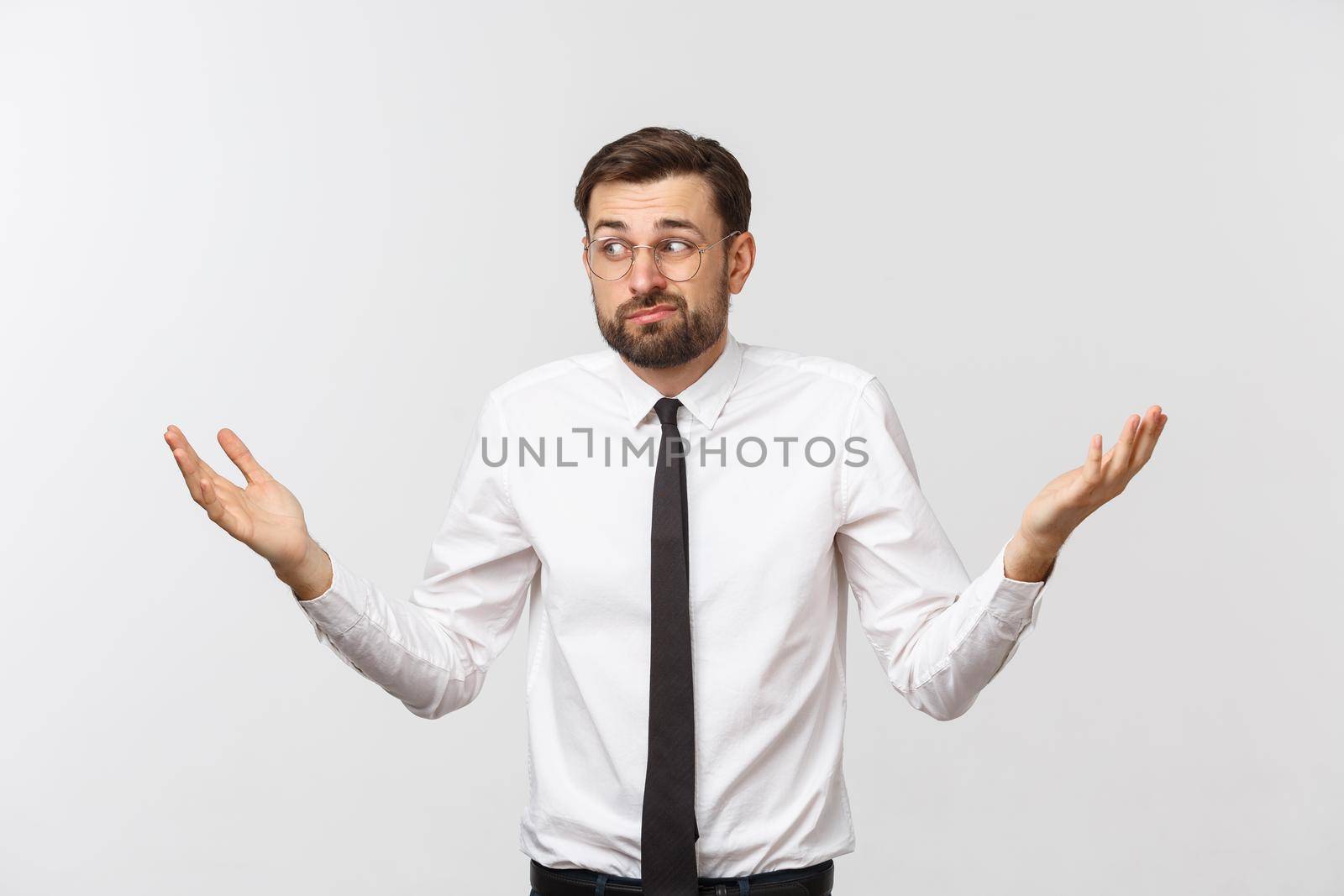 Young happy businessman gesturing with hands and showing balance or do not care