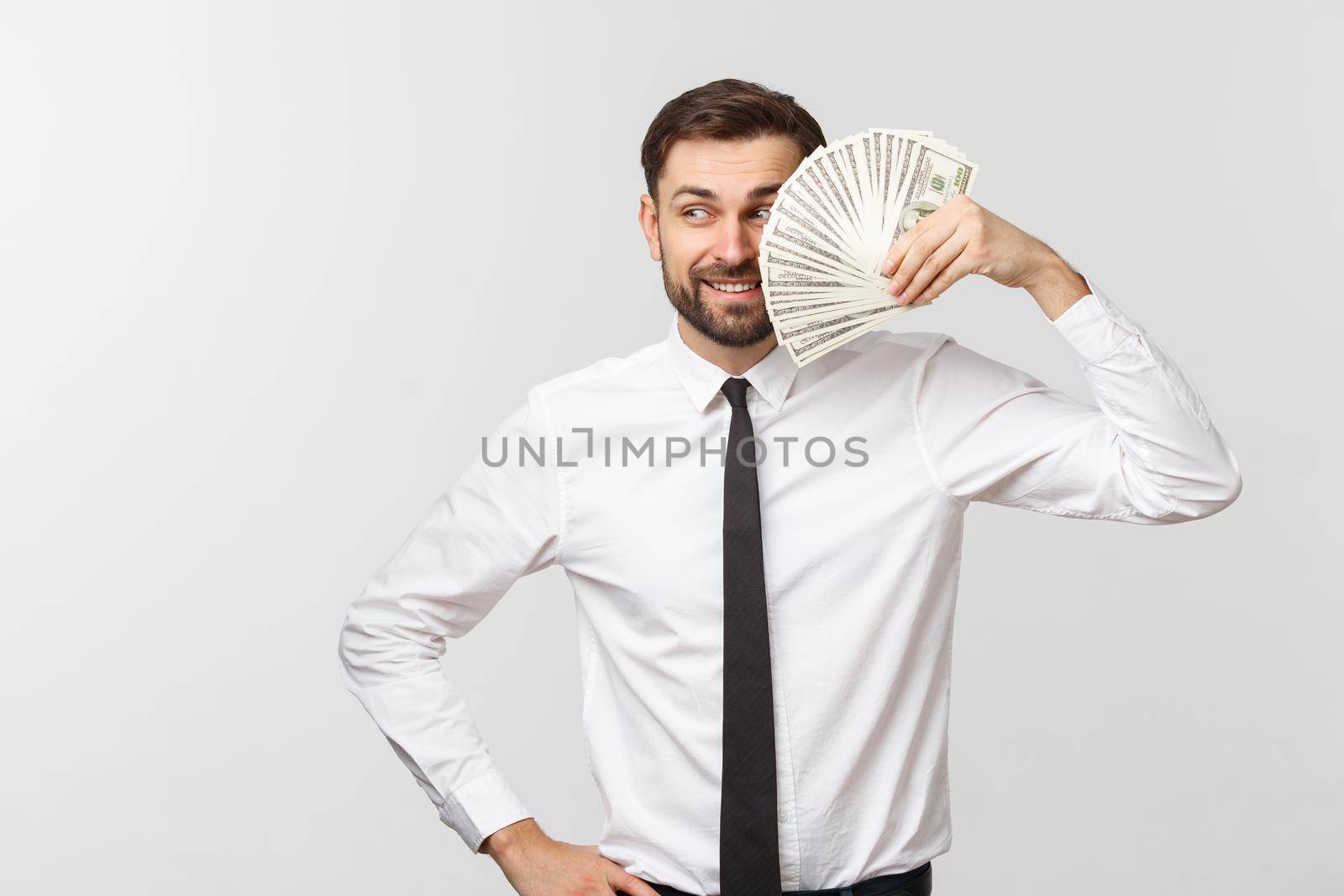 Portrait of a business man holding money, isolated on white. by Benzoix