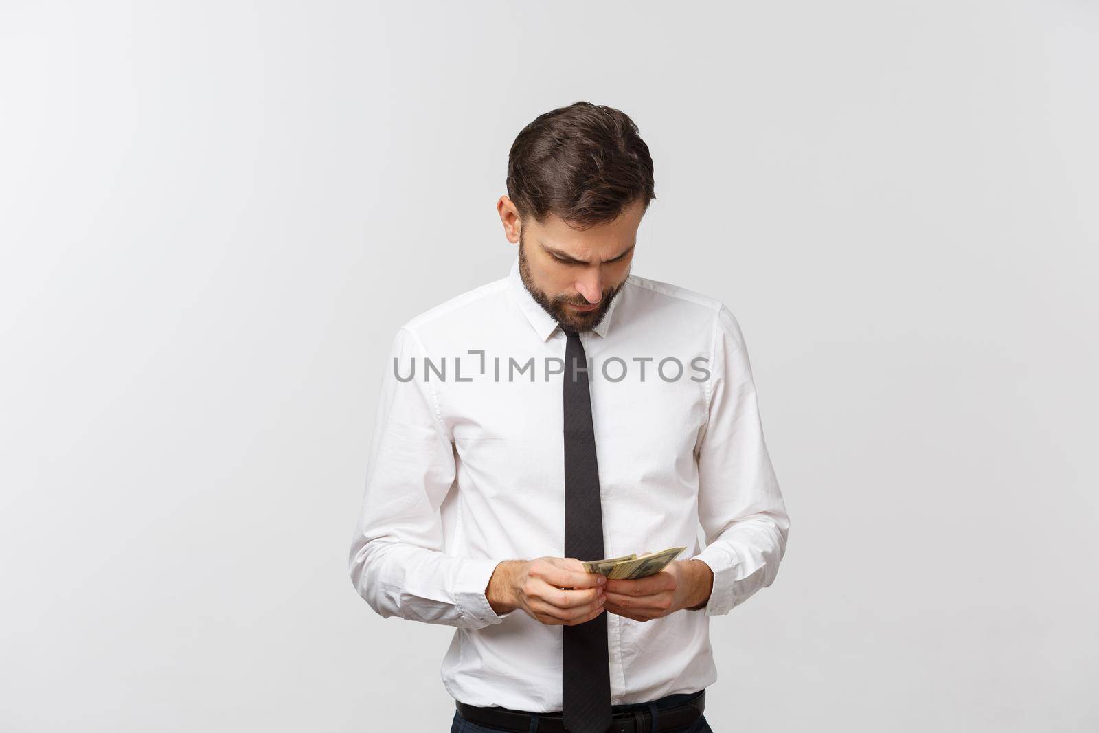 Portrait of a business man holding money, isolated on white