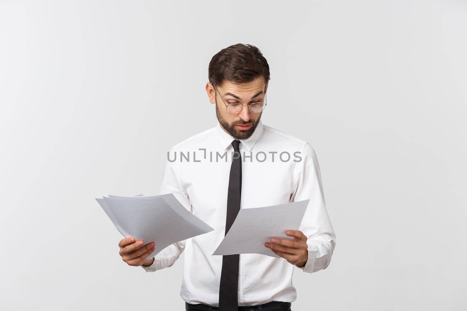 young business man serious writing on clipboard, Handsome businessman wear elegant suit and tie isolated over white background. by Benzoix