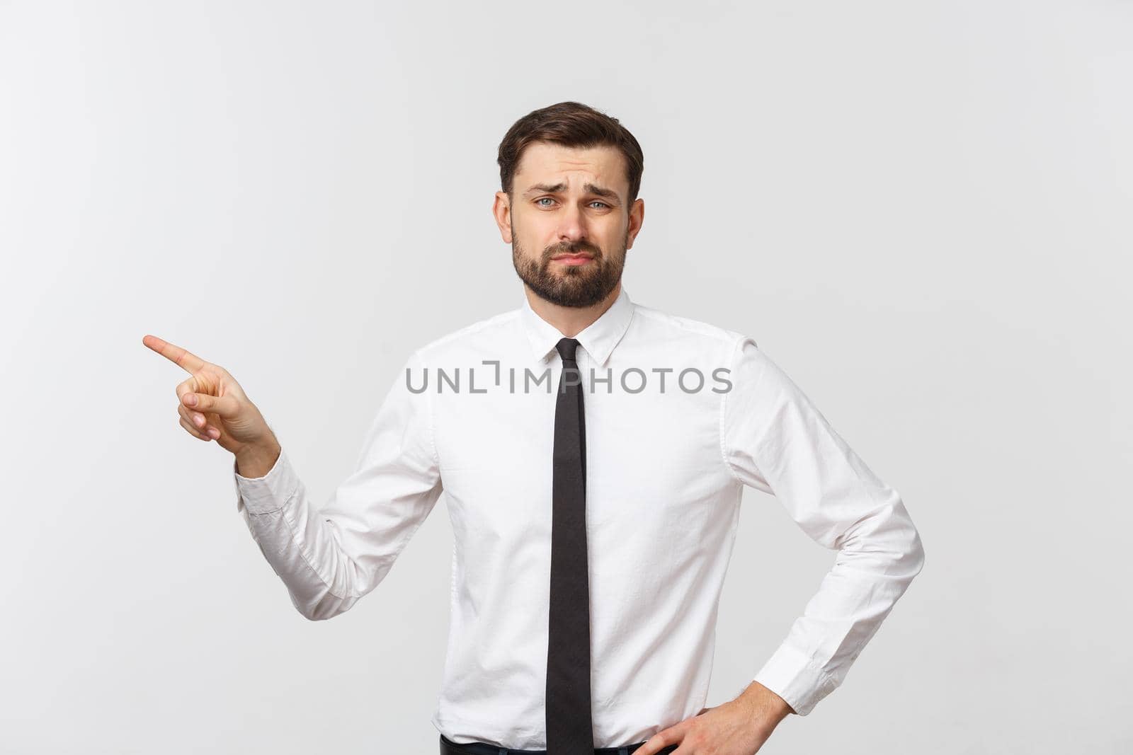 Bearded serious businessman pointing finger at you. Isolated on grey studio background by Benzoix