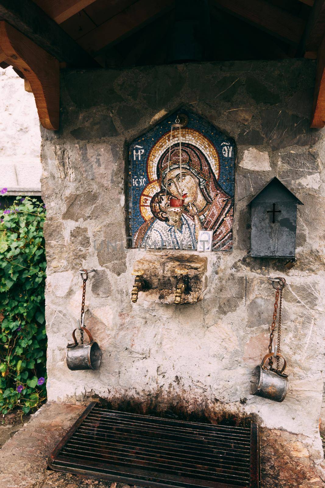 Mosaic icon of the Mother of God and Child on the stone wall of the temple. High quality photo
