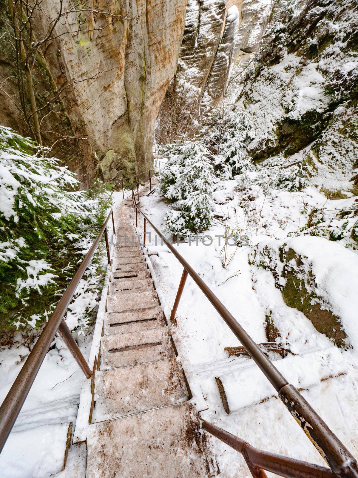 Ladder, wooden staircase and steel banister in Sandstone rocky labyrinth at Adrspach town, Czech Republic. Visit park in winter season