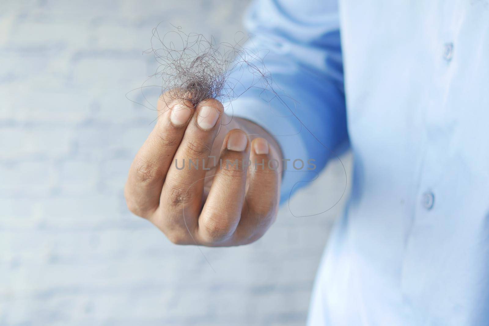 man hold his list hair close up ,