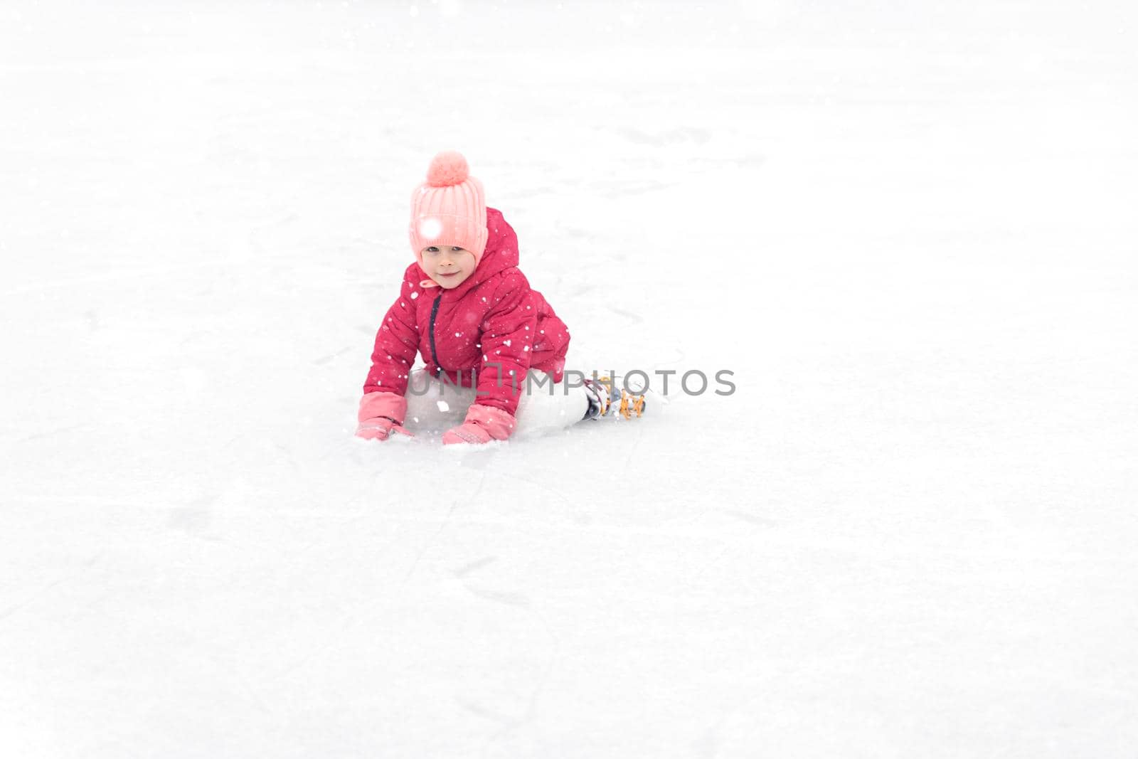 little girl ice skating on the ice rink by Lena_Ogurtsova