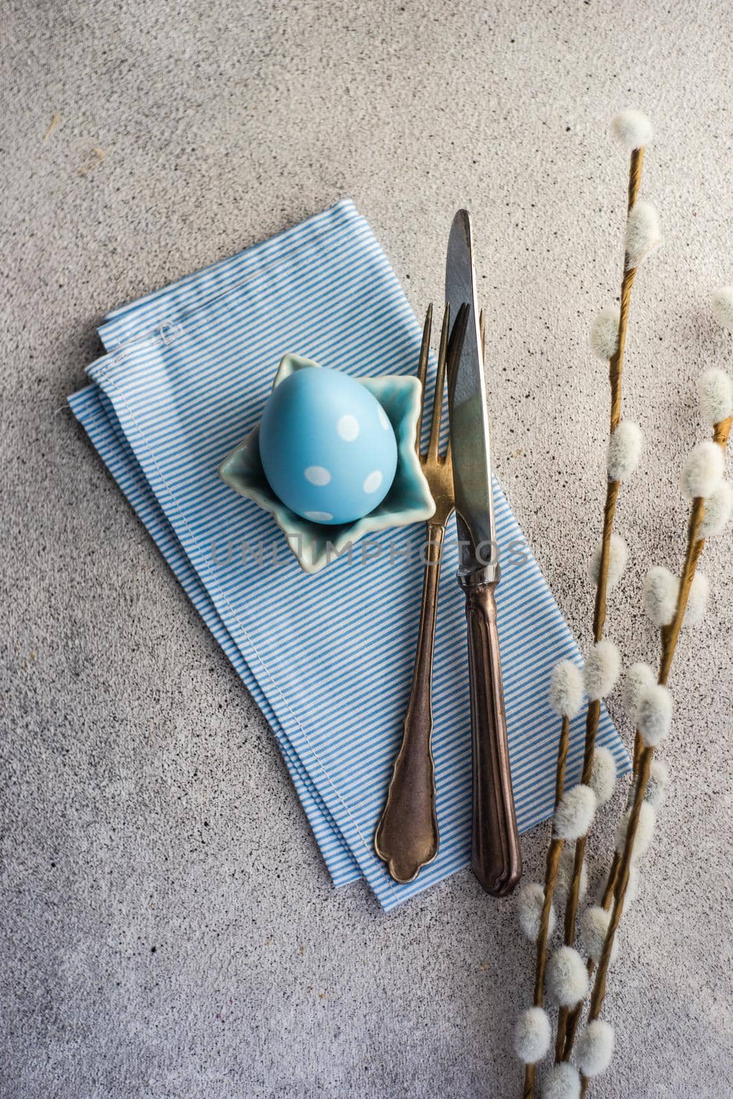 Festive table setting for holiday Easter dinner in blue color