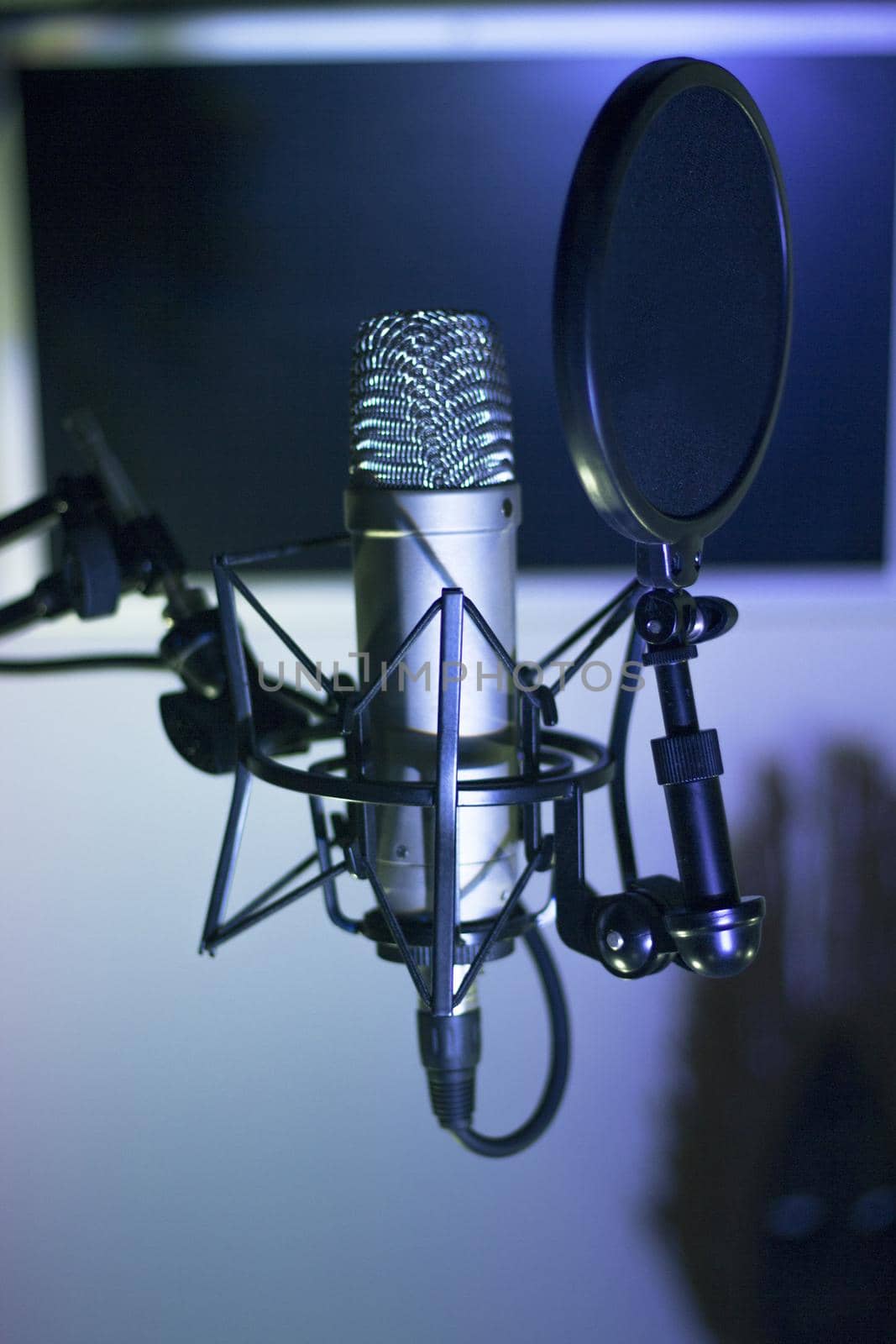 Professional microphone suspended in the air of professional studio