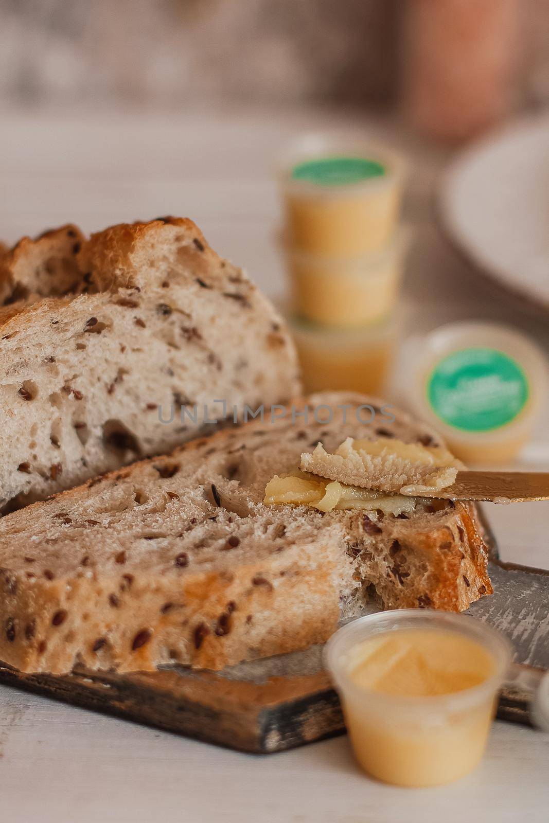 Ghee butter in glass jar and sliced bread on table. Healthy eating, breakfast by mmp1206