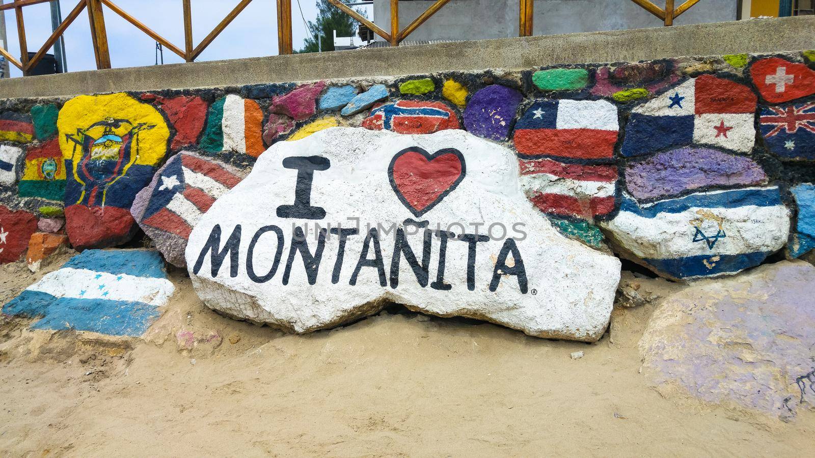 MONTANITA, ECUADOR - JANUARY 15, 2016 : Iconic stone of the town of Montanita with different painted flags