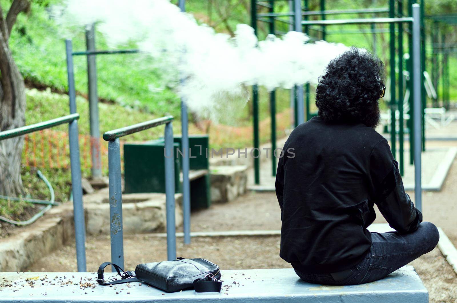 Man with beard smoking electronic sigarette outdoor