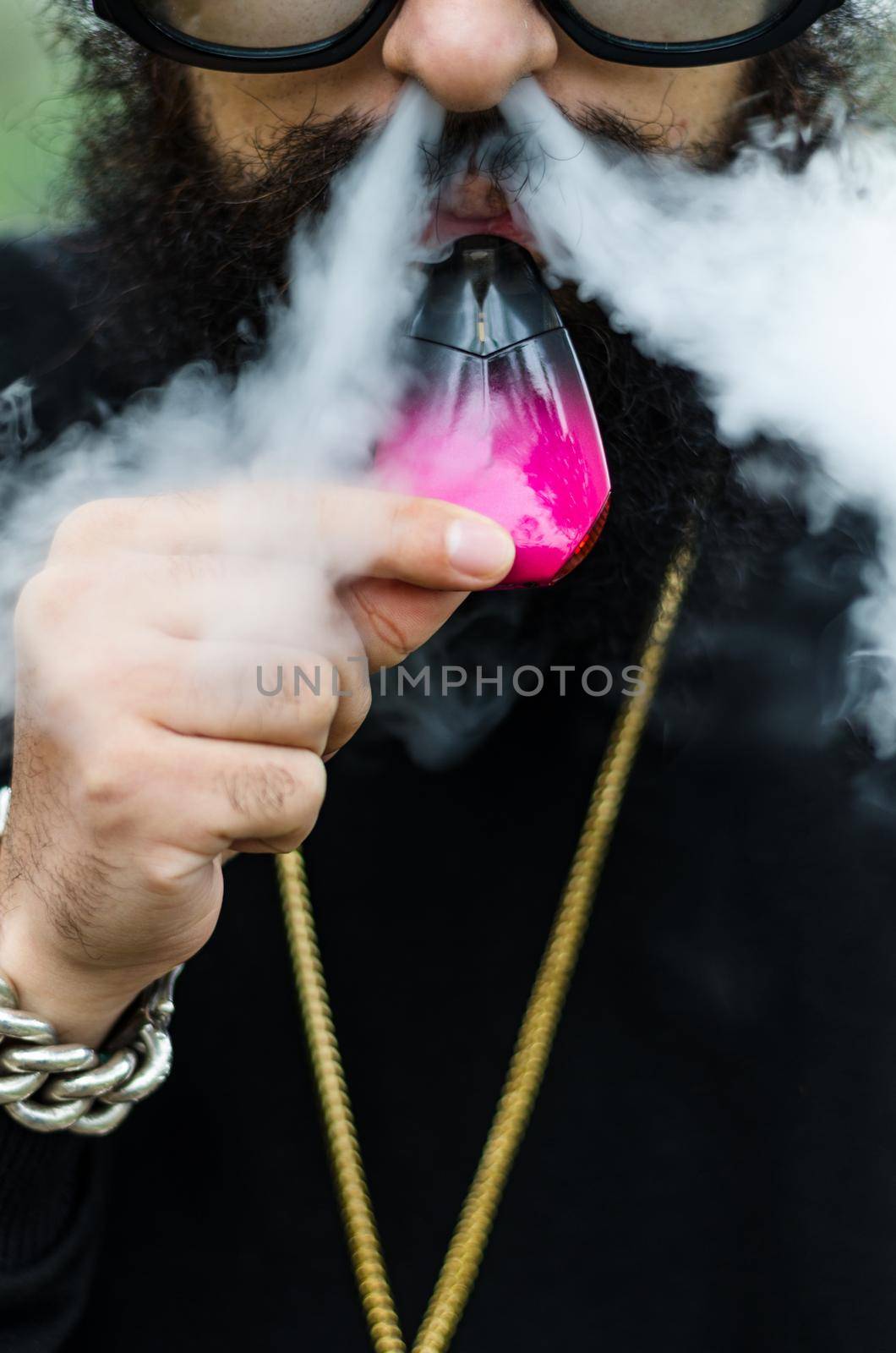 Close-up of a man with an electronic cigarette by Peruphotoart