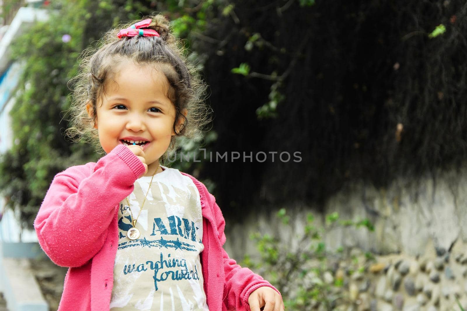 Portrait of cute girl with lollipop smiling in the park