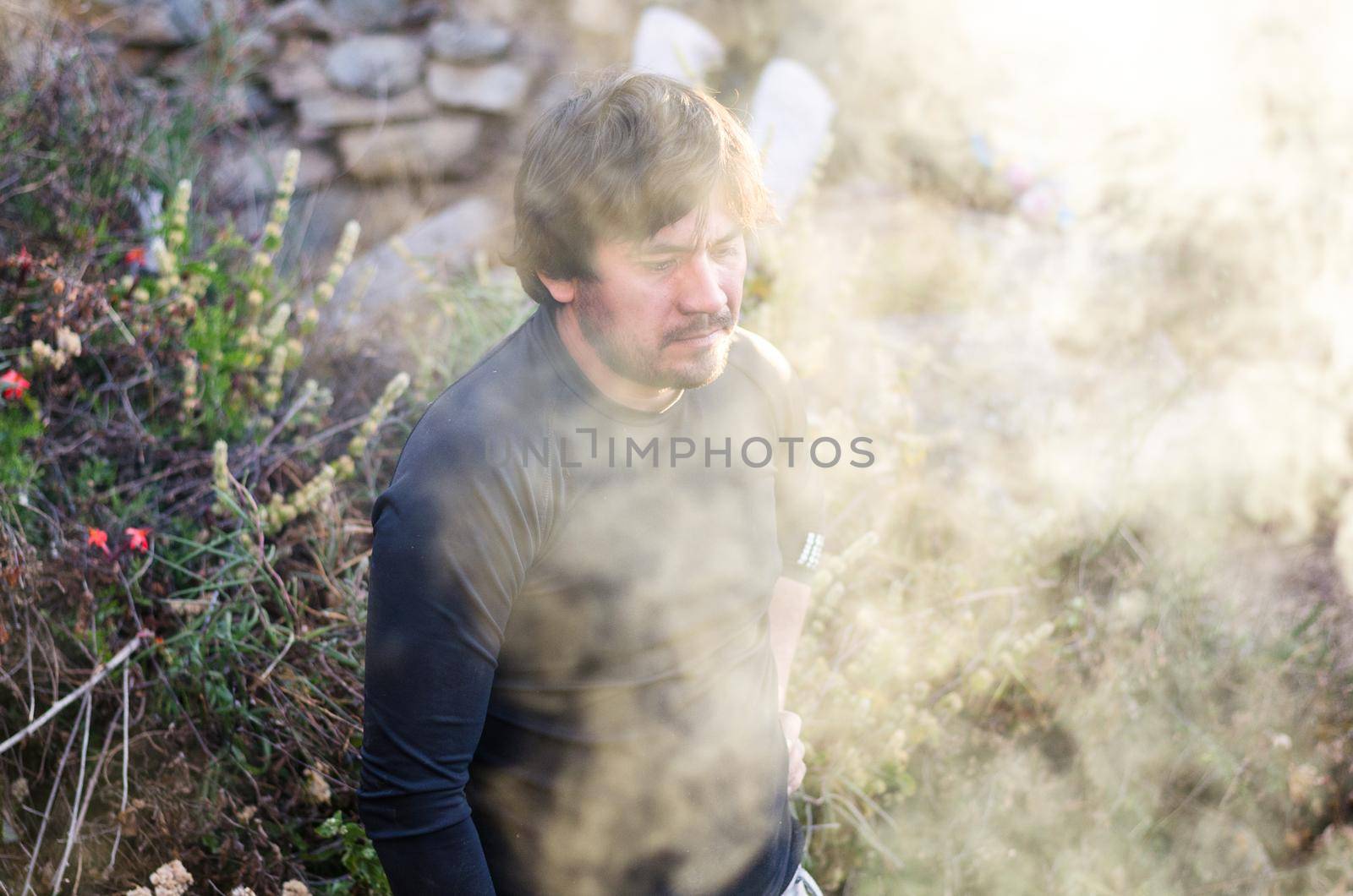 Survival Man is making bonfires in the winter forest, high on the Chiprac mountain - north of Lima - Peru