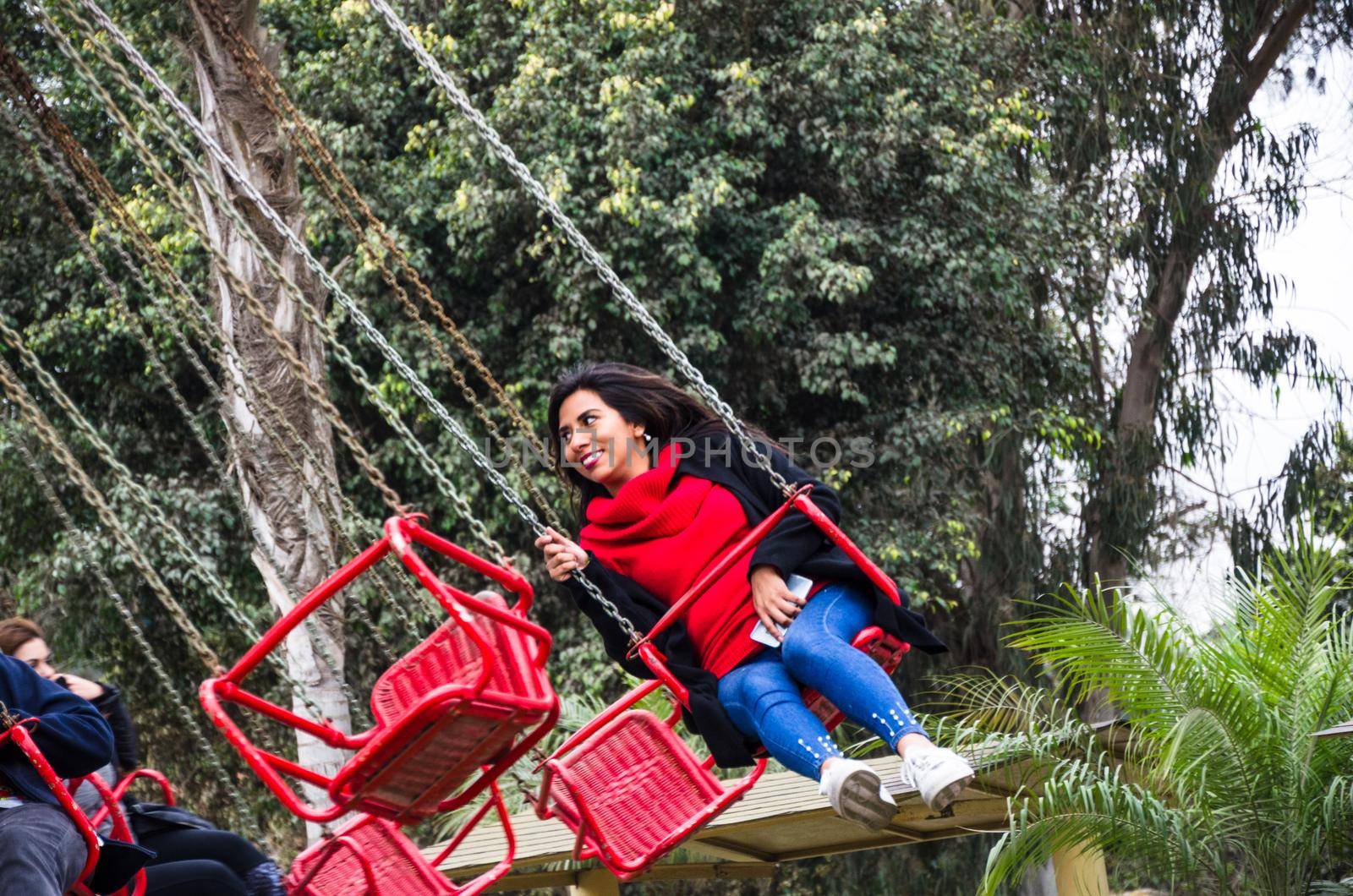 Young woman having fun and smiling in an amusement park game