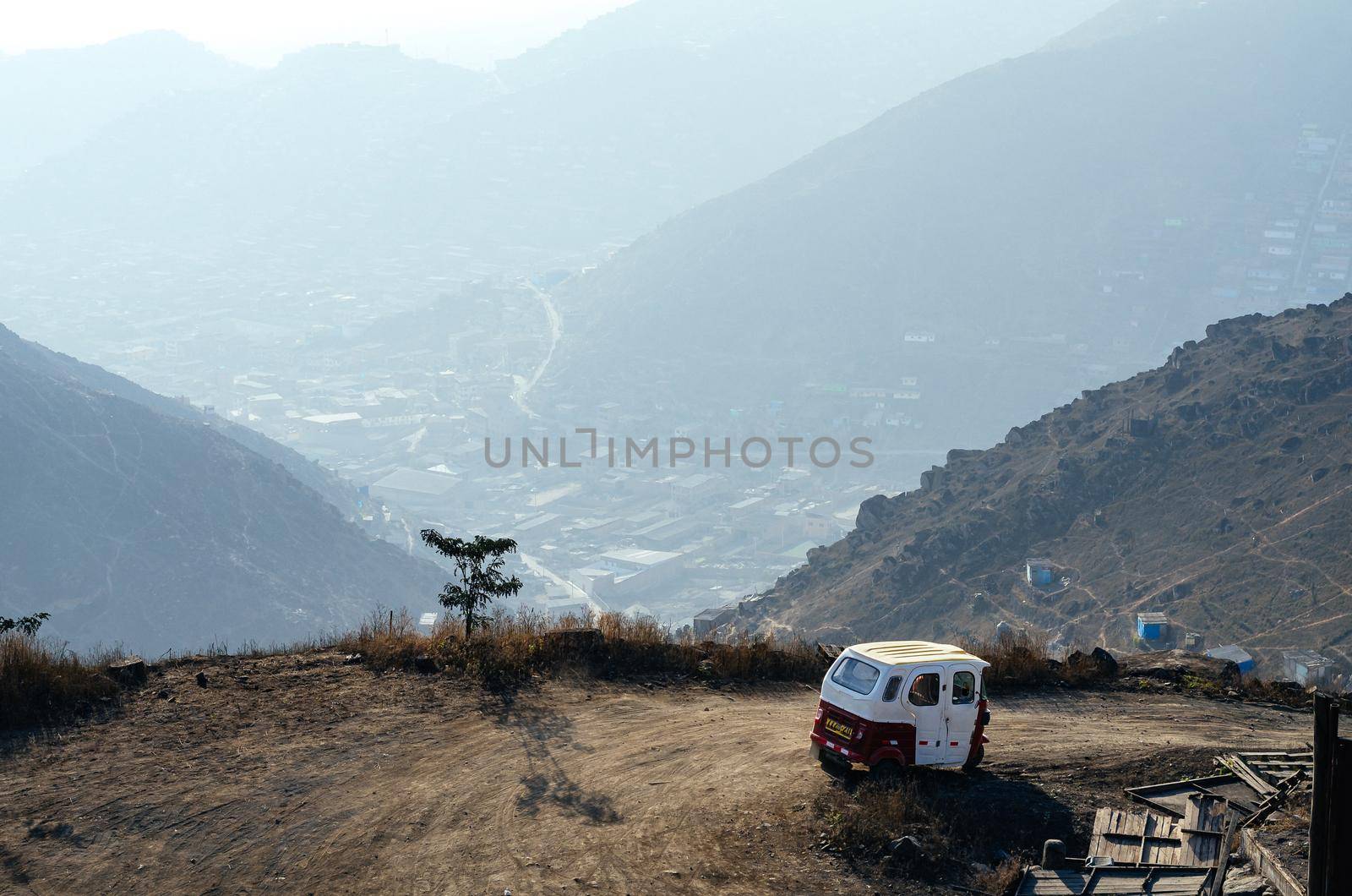 Poorly built houses in a poor neighborhood of Lima, Peru in which you can also see a vehicle called a mototaxi