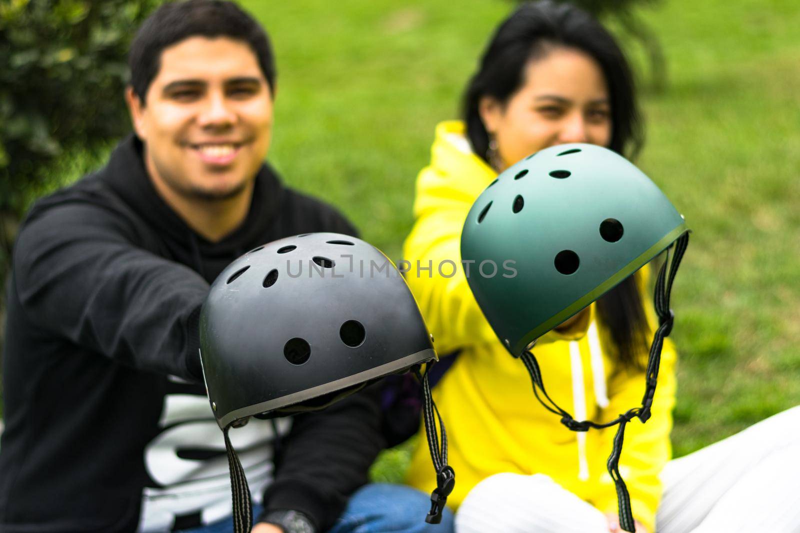 Two smiling friends showing helmet by Peruphotoart