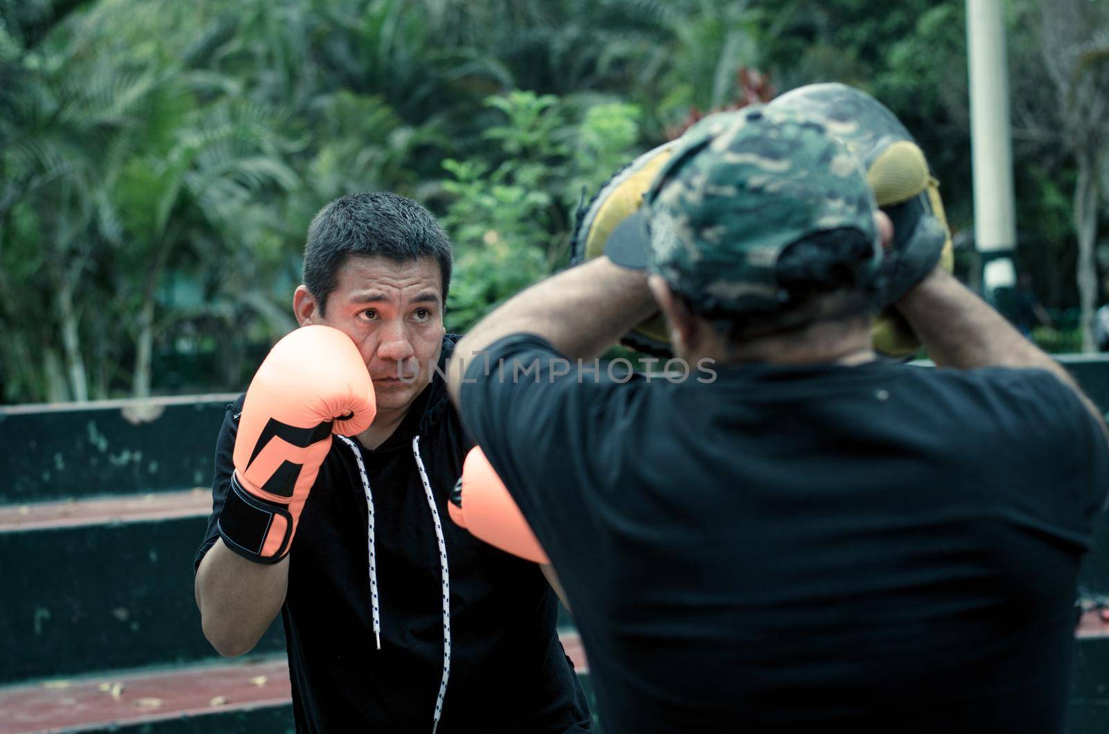 boxing outdoor workout with trainer, punching exercises with personal coach