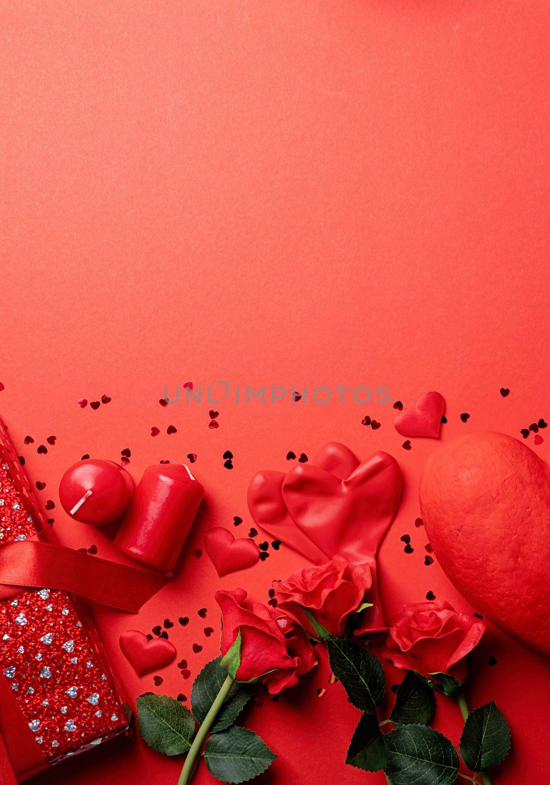Valentines Day gifts, roses and candles on red backdrop, copy space by Desperada