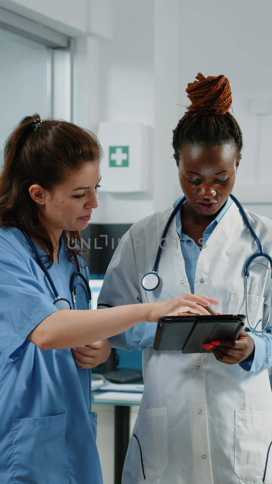 Doctor and nurse working with tablet for healthcare system by DCStudio