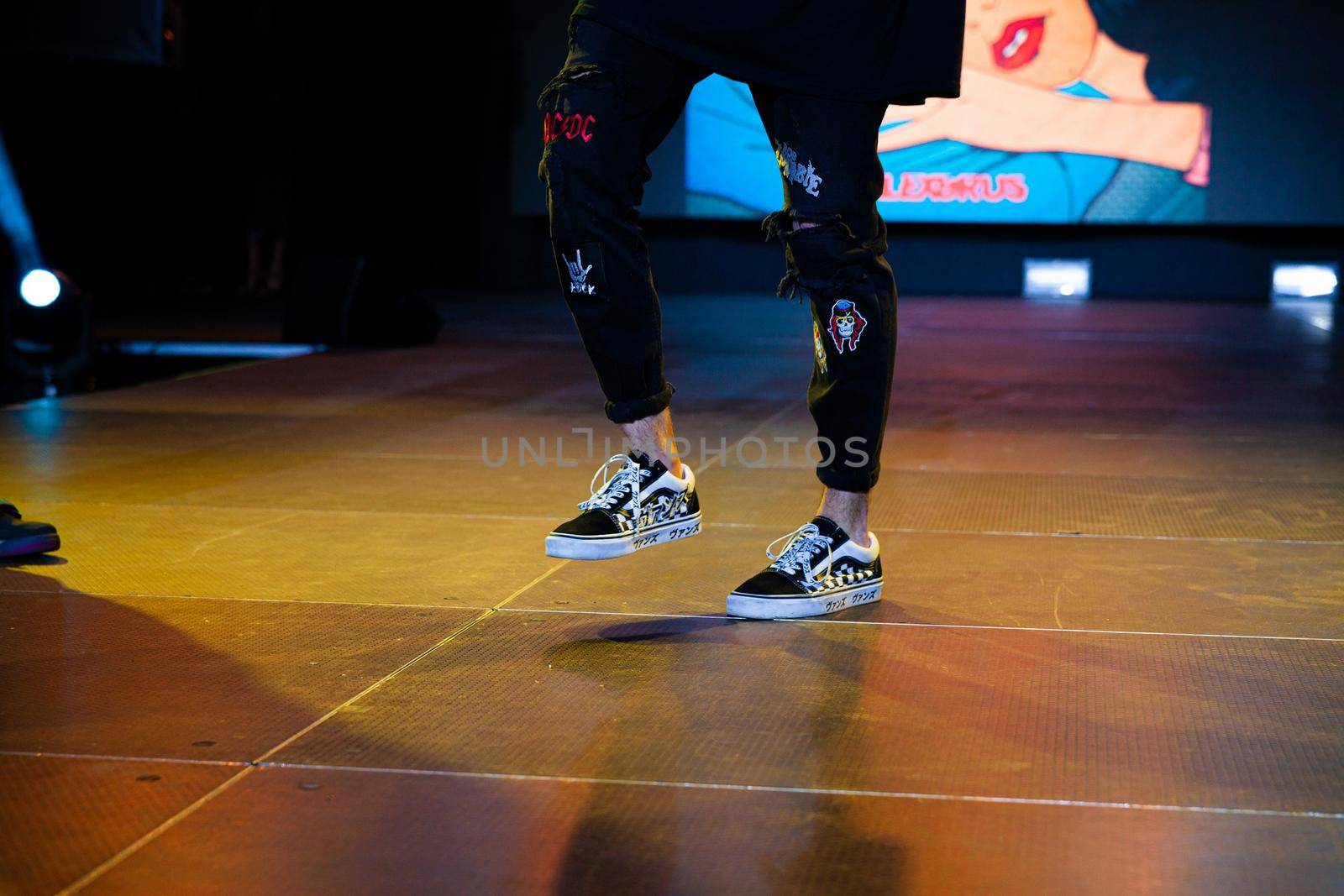 Close-up of the artist's legs during a performance by diczman