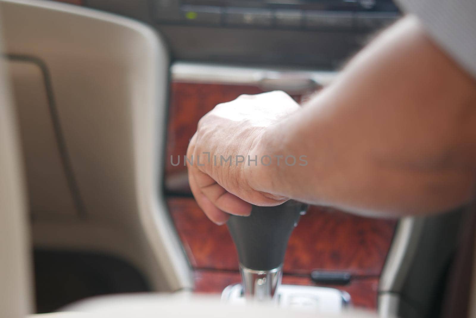 Male hand changing gear in the car