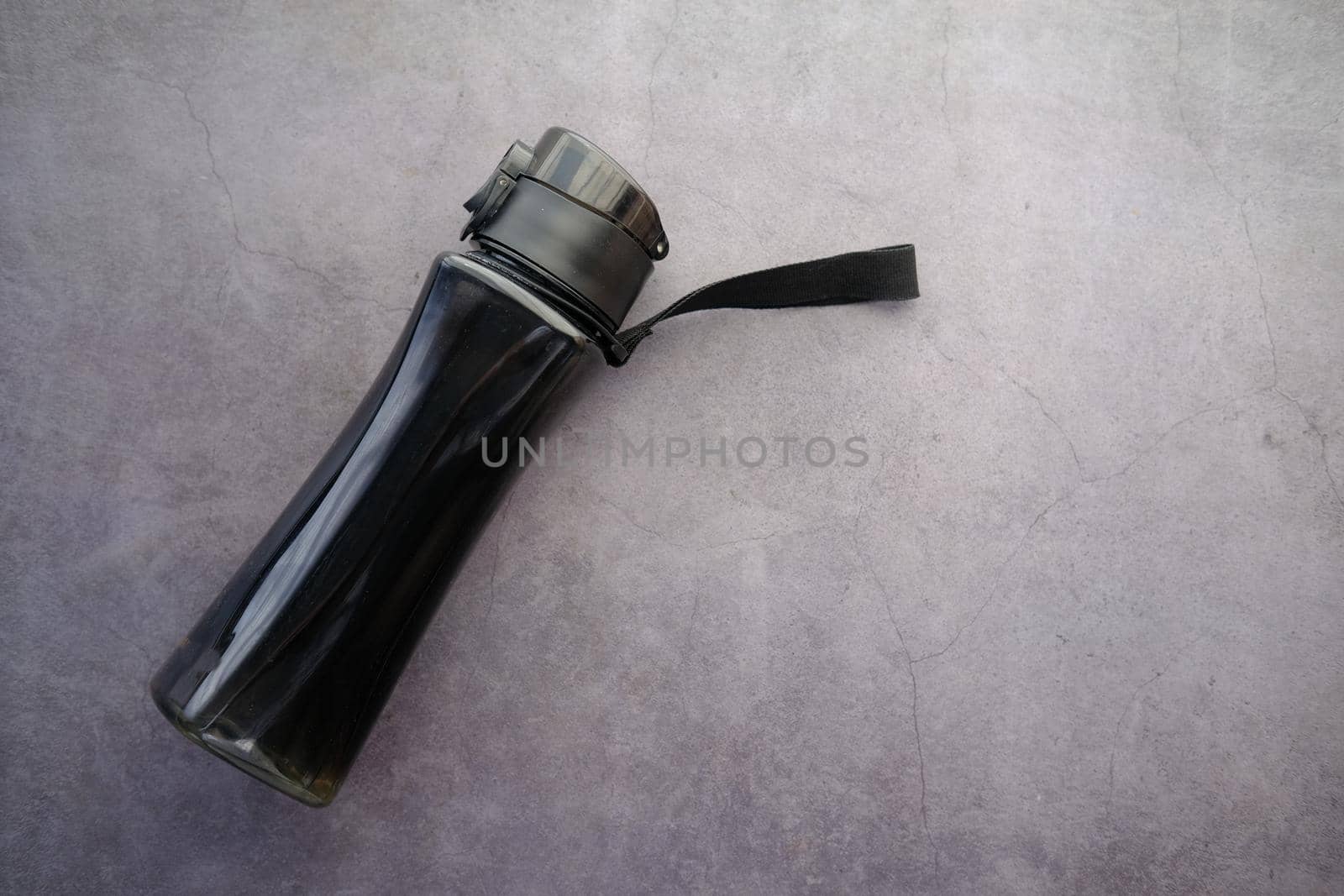 plastic bottle on water on black background .