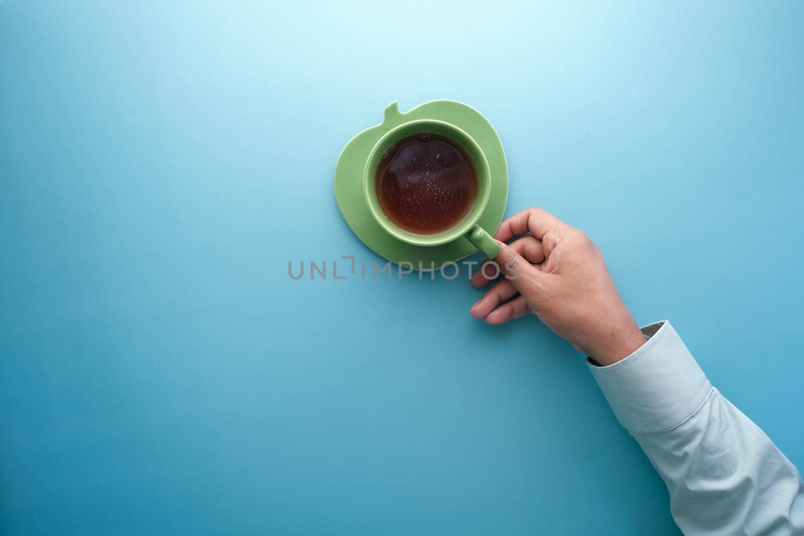hand holding cup of green tea with copy space ,
