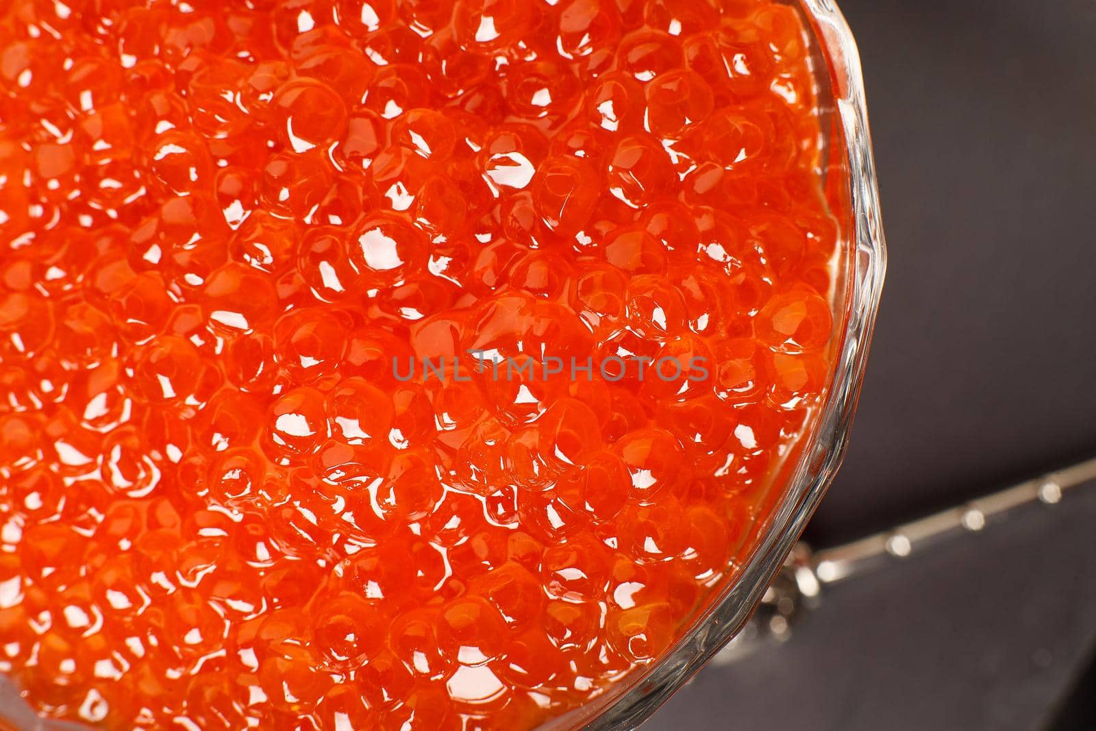 Red caviar in a glass bowl, close-up