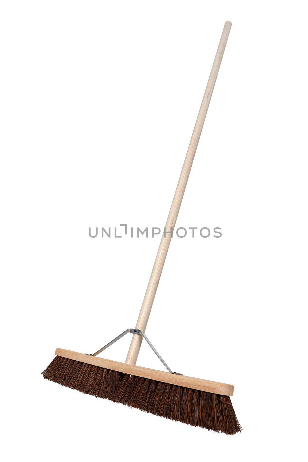 A side view of a yard broom on white background
