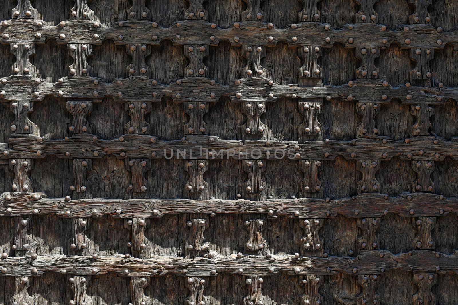 Wooden brown door with ancient square patten