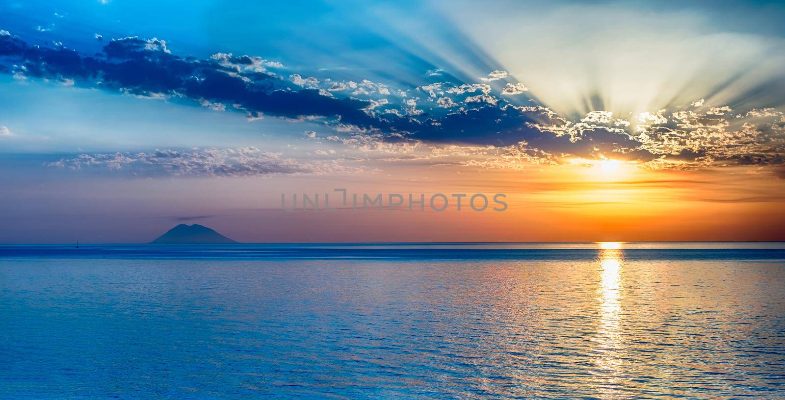 Scenic sunset with view of the Stromboli Volcano from Tropea, a seaside resort located on the Gulf of Saint Euphemia, part of the Tyrrhenian Sea, Calabria, Italy