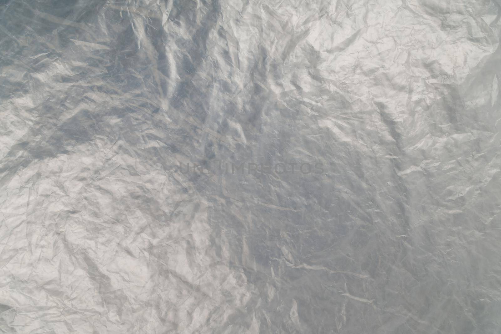 full frame background of flat crumpled semi-transparent polyethylene film.