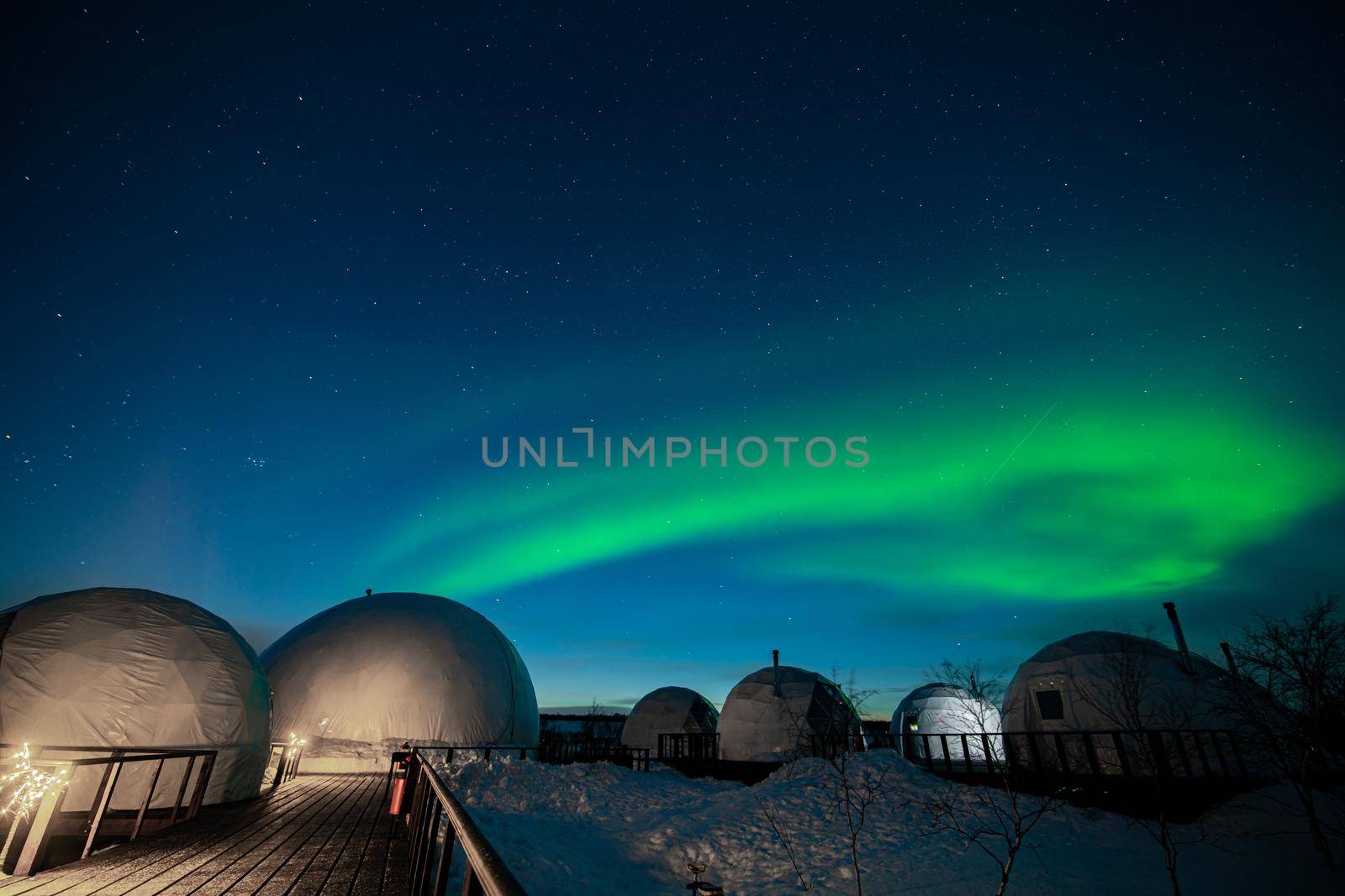 Northern Lights also known as aurora, borealis or polar lights at cold night over igloo village. Beautiful night photo of magic nature of winter landscape by MKolesnikov